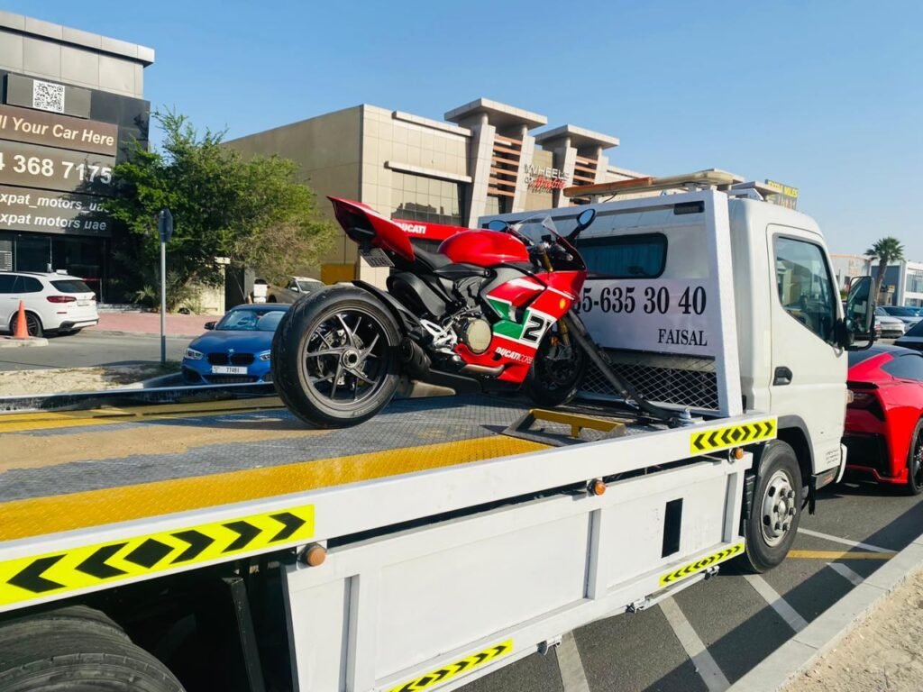Red Ducati Panigale superbike secured on a flatbed truck