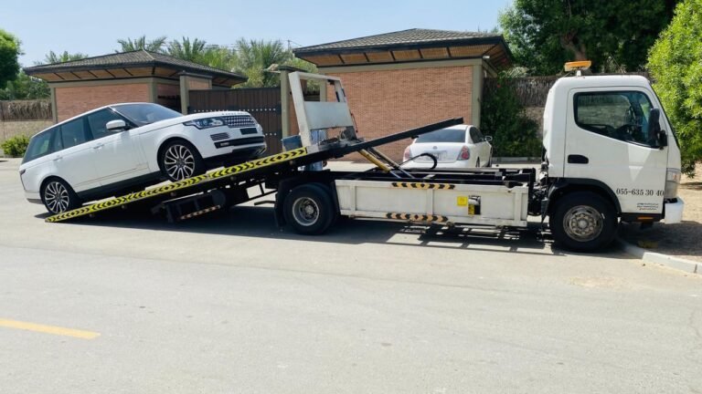 White Range Rover rolling onto a tilt-bed recovery truck