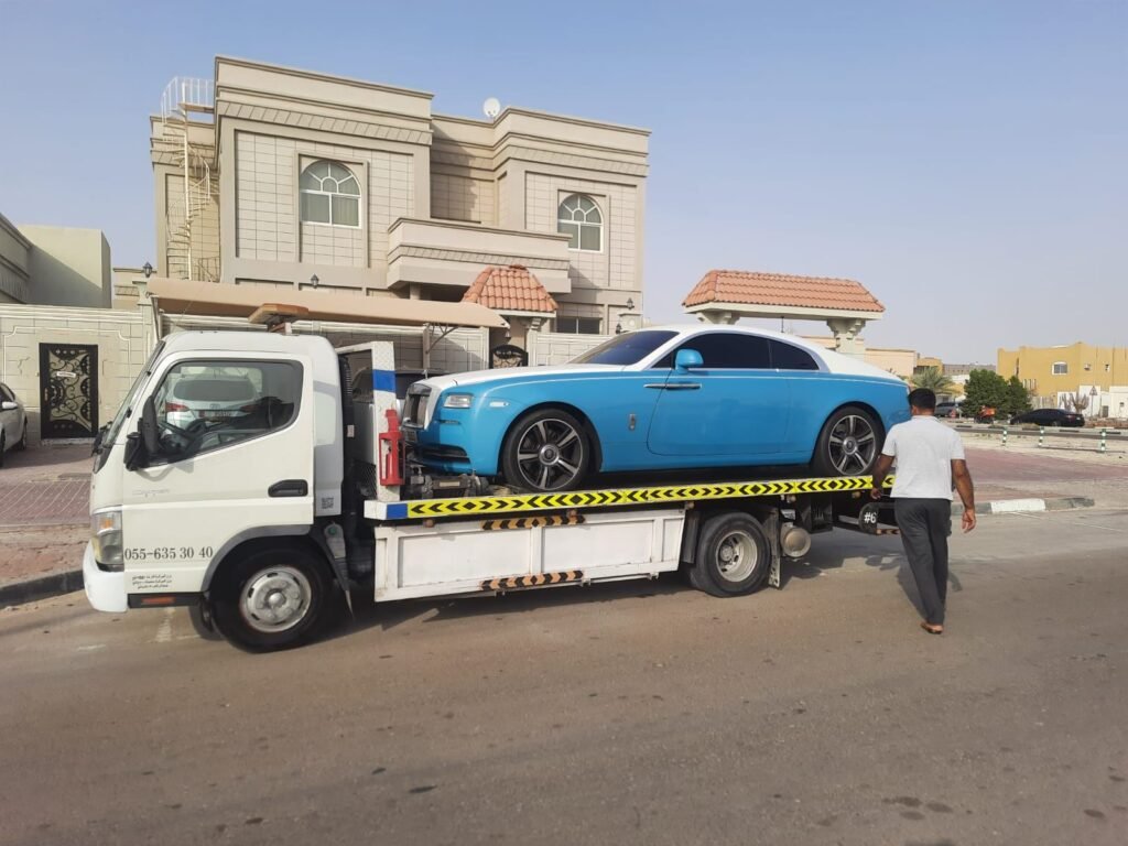Blue Rolls-Royce loaded onto a flatbed truck outside a Dubai villa