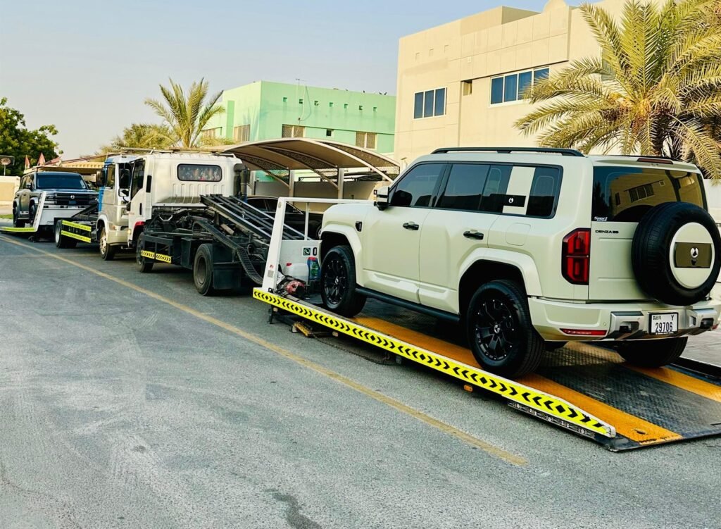 White off-road SUV being loaded onto a flatbed on a Dubai street